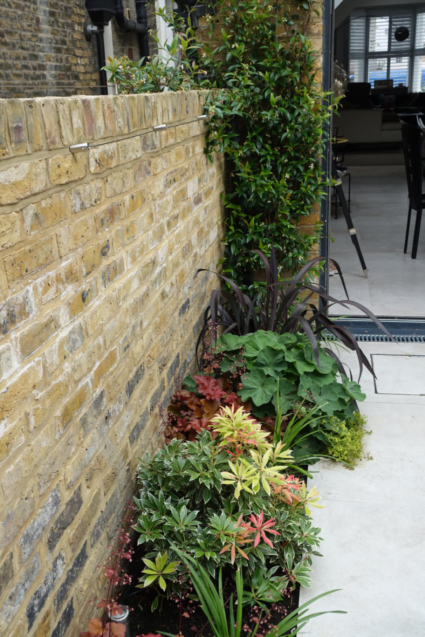 An Outdoor Fireplace in Fulham • Square Garden Design